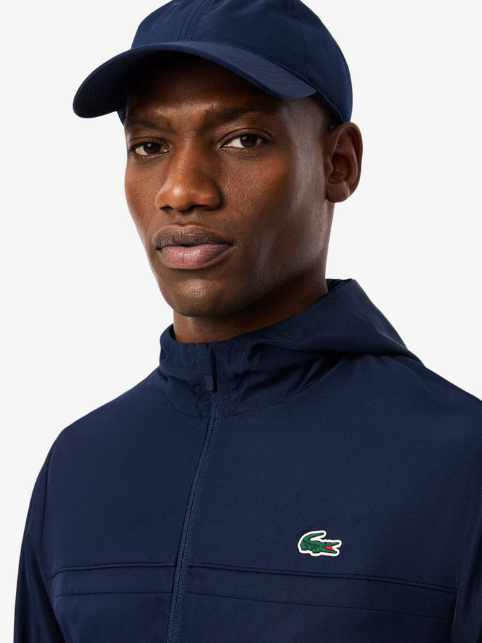 LACOSTE Sport Track Jacket Navy - Close-up detail of embroidered crocodile logo and water-repellent fabric texture