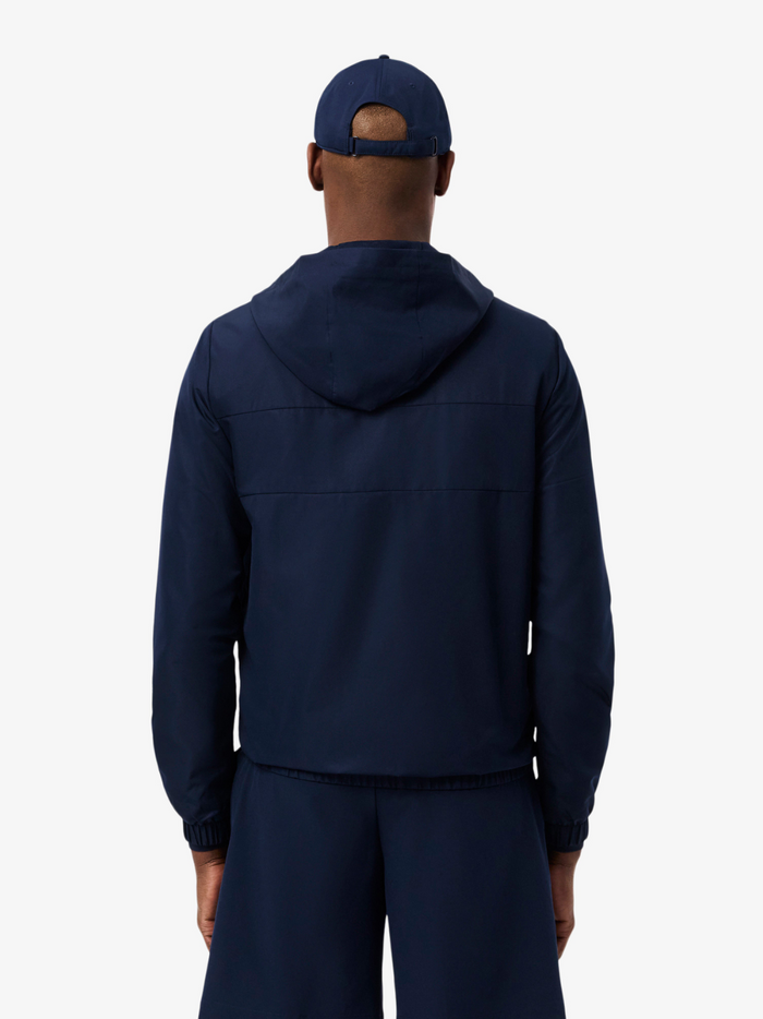 LACOSTE Navy Water-Repellent Jacket - Flat lay styling shot highlighting overall athletic design and proportions