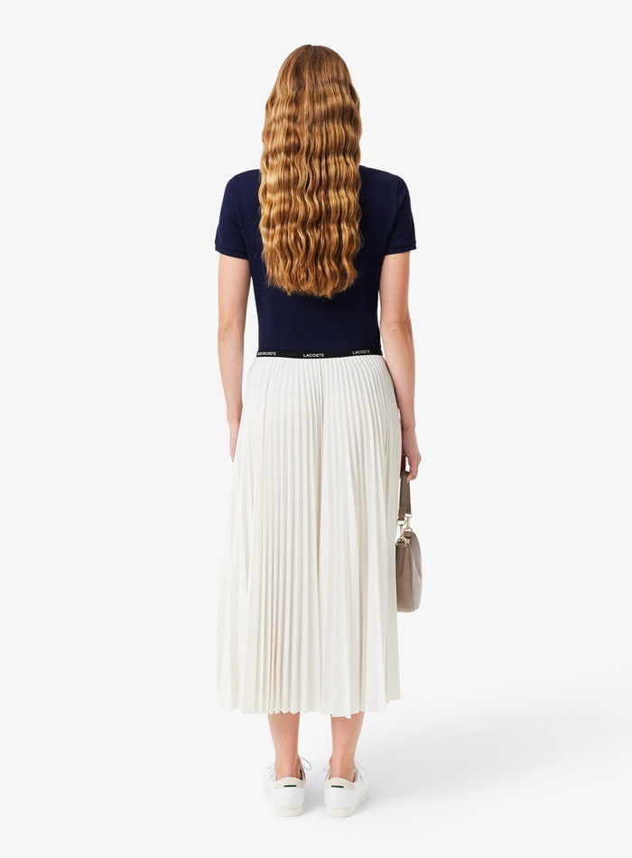Full-length view of Lacoste women's white midi pleated skirt with comfortable elastic waist